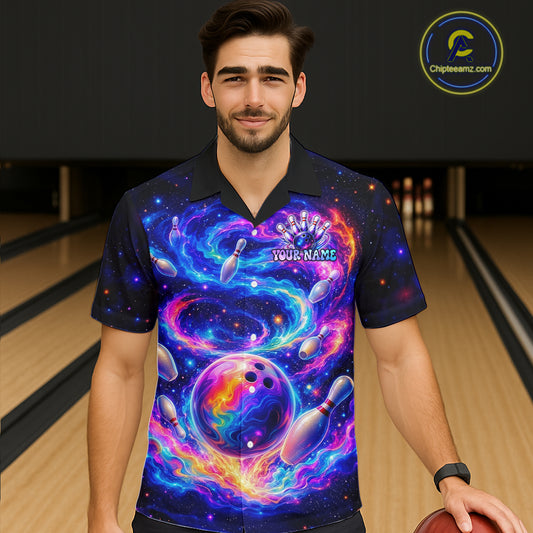 Man wearing a colorful bowling shirt with a galaxy design in a bowling alley.