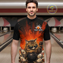 Load image into Gallery viewer, Man wearing a black t-shirt with a colorful design of a cat holding a bowling ball in a bowling alley.