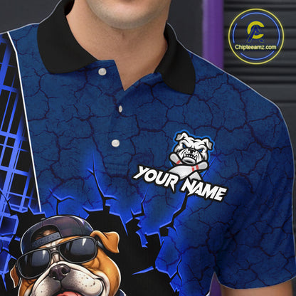 A close-up of a person wearing a blue short-sleeve polo shirt with a black collar. The shirt has a cracked blue graphic background, a bulldog mascot logo with the text 'YOUR NAME', and a large bulldog graphic in the lower left corner.
