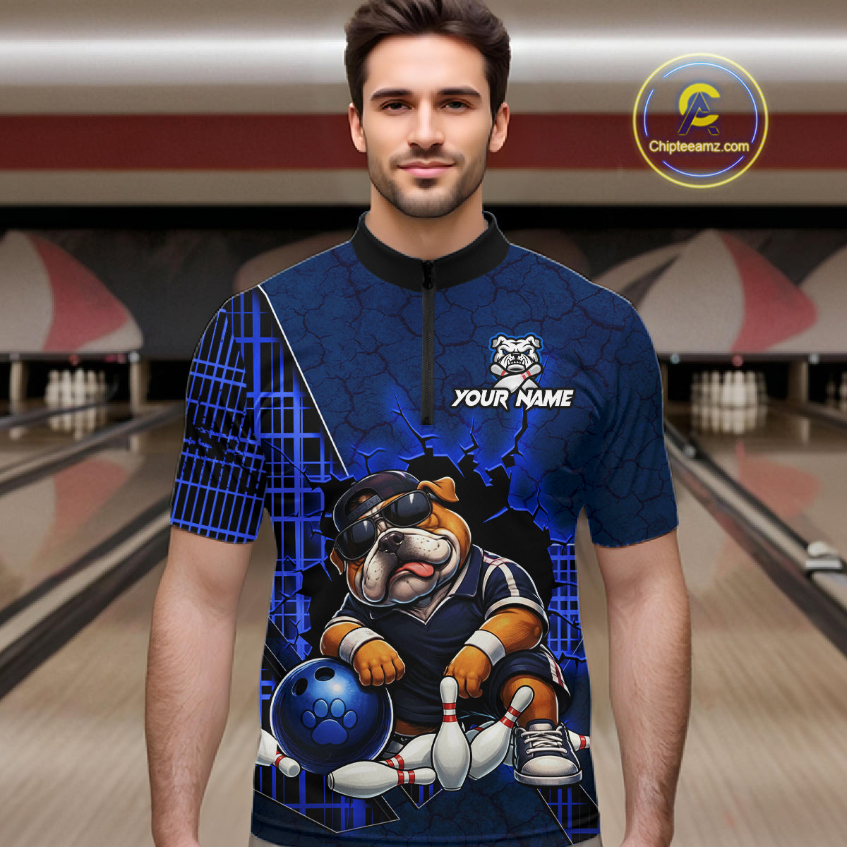 A man wearing a custom short-sleeve bowling jersey with a blue and black background, featuring a cartoon bulldog bowling graphic and the text 'YOUR NAME'. The background shows blurred bowling lanes