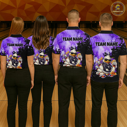 Four people standing with their backs to the camera in a bowling alley, wearing matching custom bowling shirts with a purple and black background, cartoon duck graphics, and 'TEAM NAME' text.