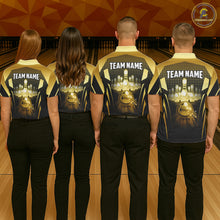 Load image into Gallery viewer, Group of four wearing custom black gold bowling shirts back view displaying personalized team names above glowing bowling ball artwork on a black gold geometric light beam background at the bowling alley