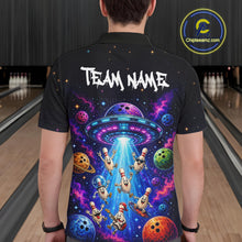 Load image into Gallery viewer, Person wearing a black bowling shirt with a colorful UFO and bowling ball design, standing in a bowling alley.