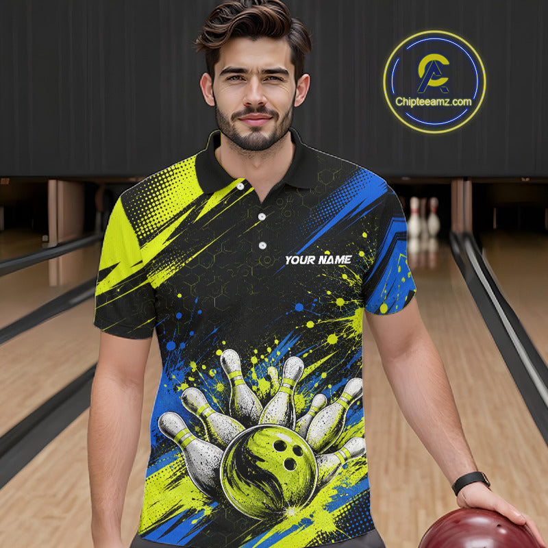 A man wearing a custom bowling-themed short-sleeve polo shirt with a black, neon yellow, and blue print featuring bowling pins, a bowling ball, and the text 'YOUR NAME'. The background shows bowling lanes