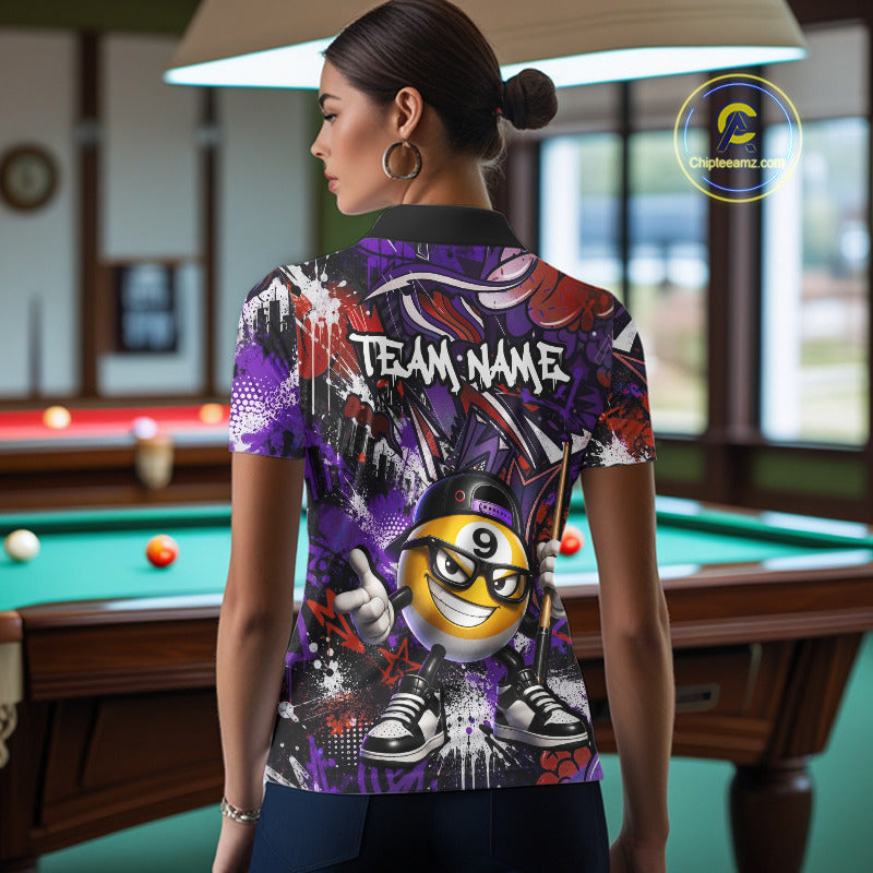 Person wearing a colorful polo shirt with a smiley billiard ball design in a pool hall.