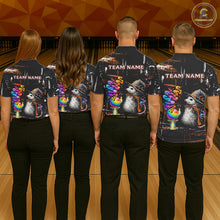 Load image into Gallery viewer, Four people standing with their backs to the camera in a bowling alley, wearing matching dark short-sleeve shirts with a colorful graphic print of opossum wearing hats and rainbow bowls, plus 'TEAM NAME' text on the back.