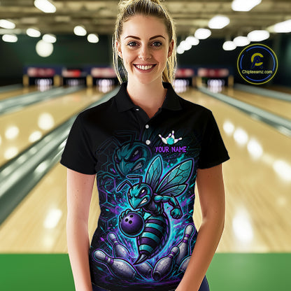 Woman wearing a black bowling quarter zip with teal and purple bee graphics, custom team text, bowling pins, and a purple bowling ball.