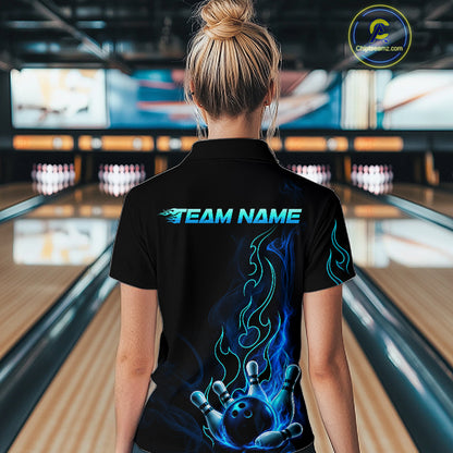A woman viewed from behind wearing a black short-sleeve polo shirt with a custom bowling-themed graphic. The shirt features 'TEAM NAME' printed in glowing blue text across the upper back, with a large blue and black flame-and-ball design on the lower back.