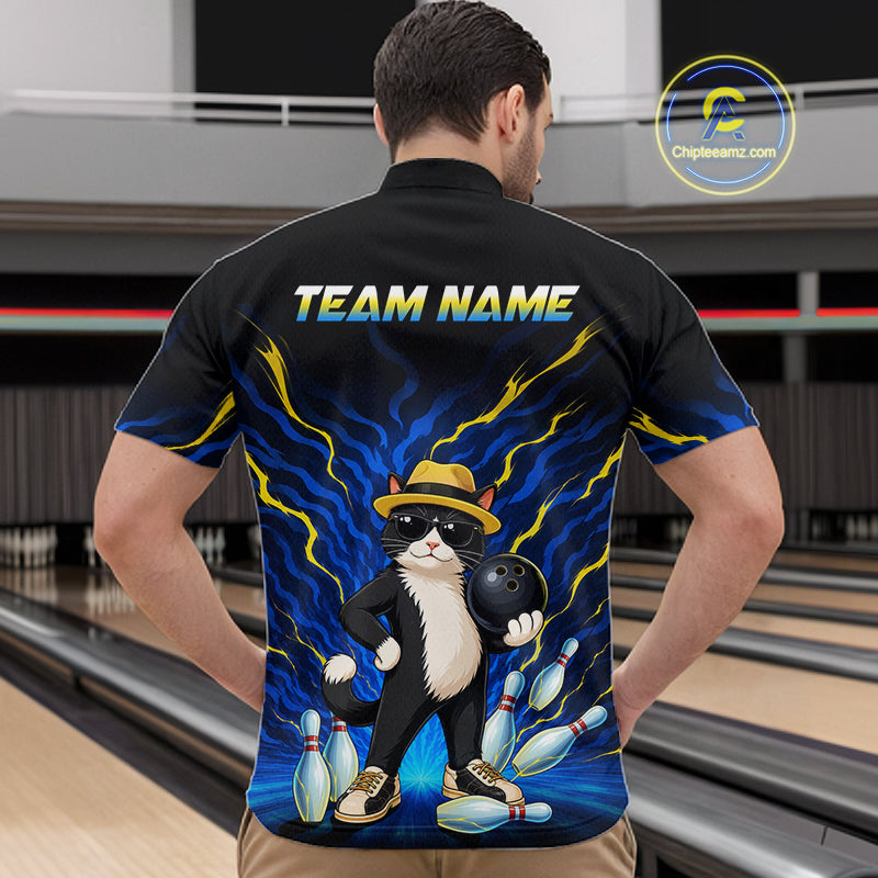 A man viewed from behind wearing a black short-sleeve bowling shirt with a colorful graphic of a cat holding a bowling ball, set in a bowling alley. The shirt features the text 'TEAM NAME' on the back.