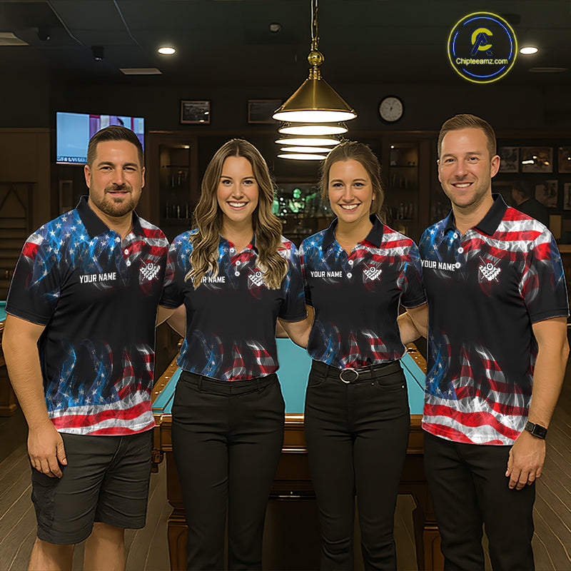 Four people standing together in a dimly lit bar or lounge, wearing matching dark polo shirts with a red, white, and blue American flag graphic and 'YOUR NAME' printed on the chest. A pool table is visible behind them, and a circular 'CrewWinc' logo appears in the top right corner.