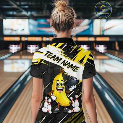 Women wearing a bowling-themed shirt with a cartoon banana character in a bowling alley.