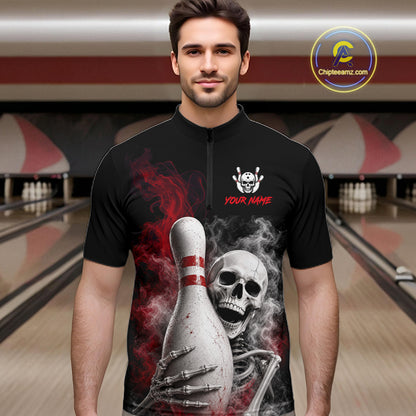 A man wearing a black short-sleeve zip-up bowling shirt with a large graphic of a skeleton holding a bowling pin, red smoke details, and 'YOUR NAME' text on the chest, set against a blurred bowling alley background.
