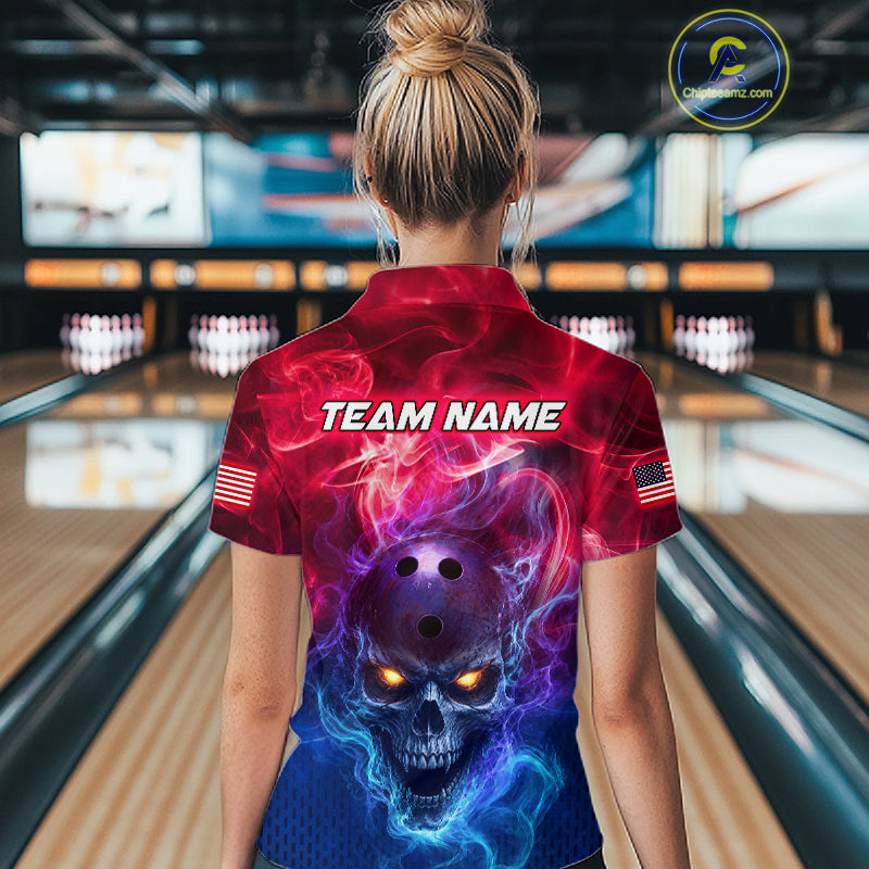 A woman viewed from behind wearing a short-sleeve bowling shirt with a red, purple, and blue skull graphic on the back, standing in a bowling alley. The shirt has 'TEAM NAME' printed across the upper back and small American flag patches on the sleeves.