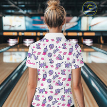 Load image into Gallery viewer, Woman wearing a white shirt with pink cat pattern in a bowling alley.