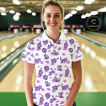 Load image into Gallery viewer, Woman wearing a white polo shirt with purple cat pattern in a bowling alley.