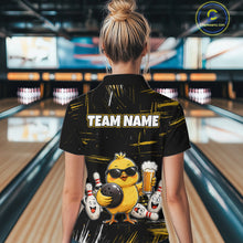 Load image into Gallery viewer, Women wearing bowling polo shirt featuring a chick holding a bowling ball surrounded by smiling pins and beer graphics on black yellow background.