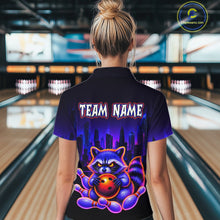 Load image into Gallery viewer, Women wearing bowling quarter zip shirt featuring a raccoon holding a bowling ball framed by pins with purple city skyline background.