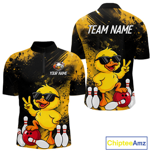 Custom short-sleeve athletic jersey shown from the front and back, featuring a cartoon yellow duck wearing black sunglasses with bowling pins and a red bowling ball, on a black and yellow splatter background. The front has a quarter-zip collar and placeholder text 'YOUR NAME', while the back has 'TEAM NAME' in white.