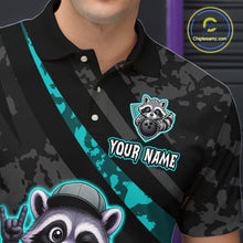 Load image into Gallery viewer, Black polo shirt with raccoon graphic and 'Your Name' text, brand logo visible