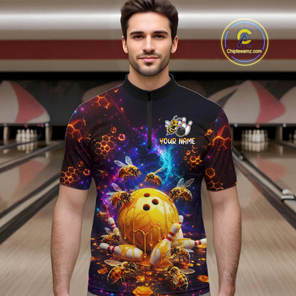 Man wearing a colorful bowling jersey with a design of a bowling ball and bees in a bowling alley.