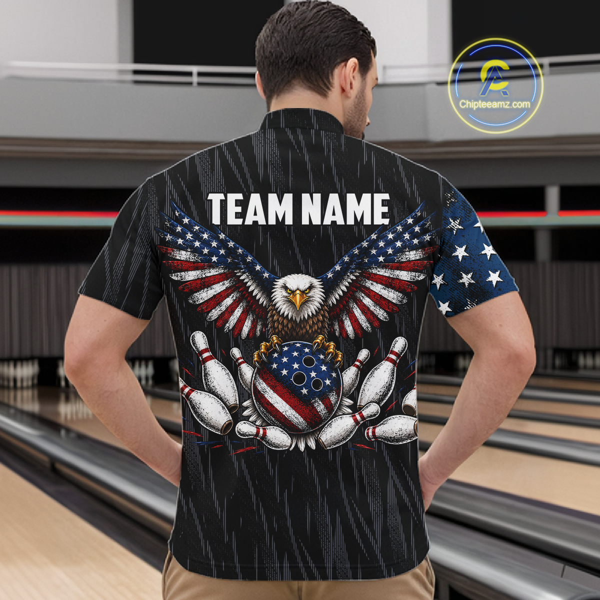 Man wearing a black patriotic bowling quarter zip shirt featuring distressed American flag graphics, custom team and player name text, and a bald eagle with spread wings above a flag-themed bowling ball and pins.