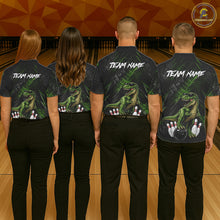 Load image into Gallery viewer, Four people wearing bowling polo shirt featuring a dinosaur standing among bowling pins and ball artwork on black green textured background.