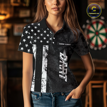 Load image into Gallery viewer, Women wearing darts polo shirt featuring dartboard patterns layered with american flag graphics and geometric details on a black background.
