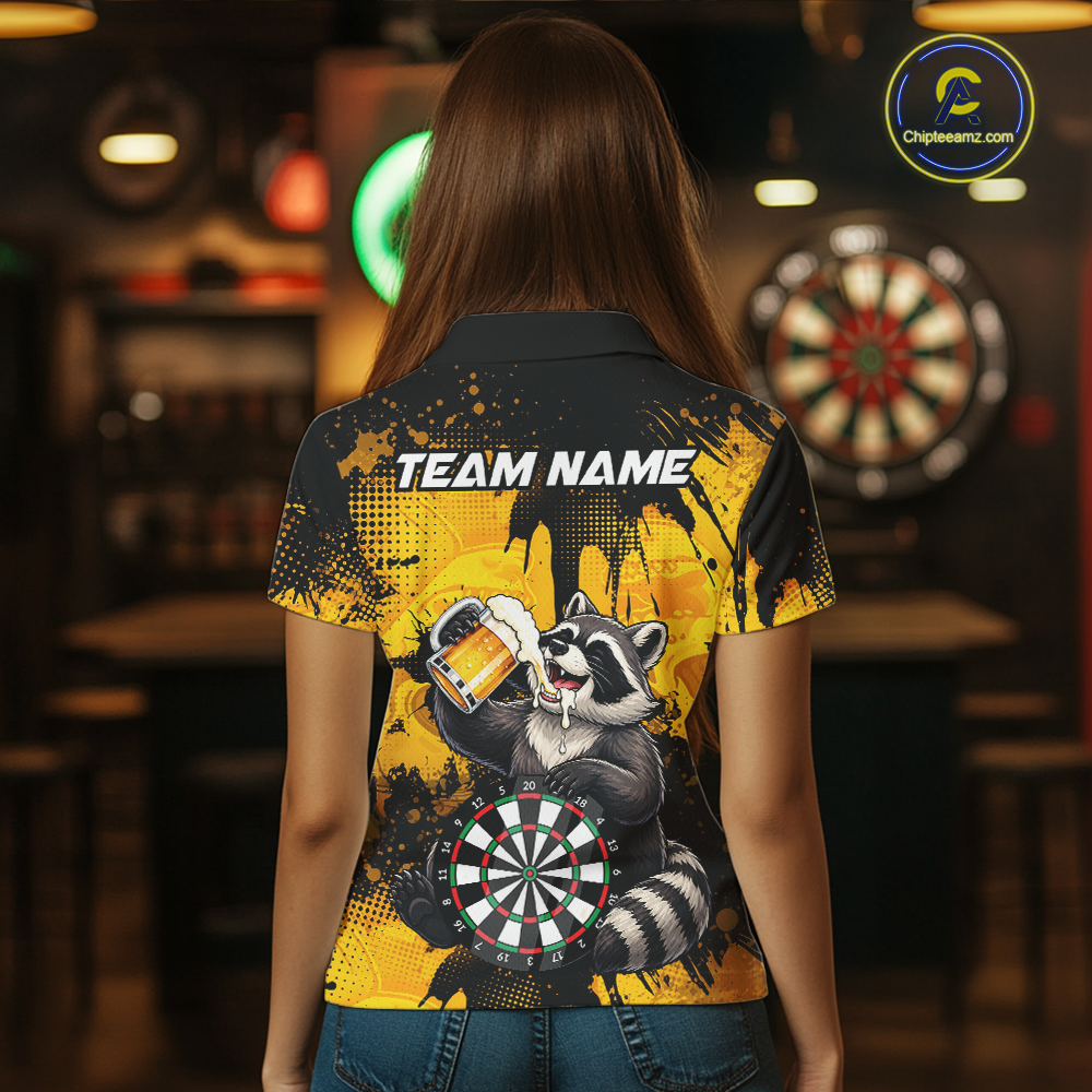 Person wearing a black and yellow darts polo featuring a raccoon drinking beer, dartboard graphics, and custom team and player name text.
