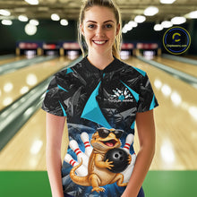 Load image into Gallery viewer, Women’s turquoise bearded dragon bowling quarter zip shirt, front view on female model in bowling lane 