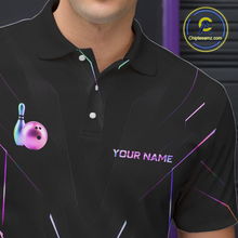 Load image into Gallery viewer, Black polo shirt with colorful bowling ball and pin design on a person, brand logo visible.