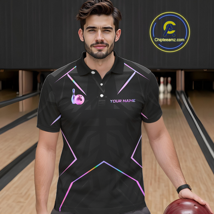 Man wearing a black bowling shirt with colorful designs and text on a bowling alley background.