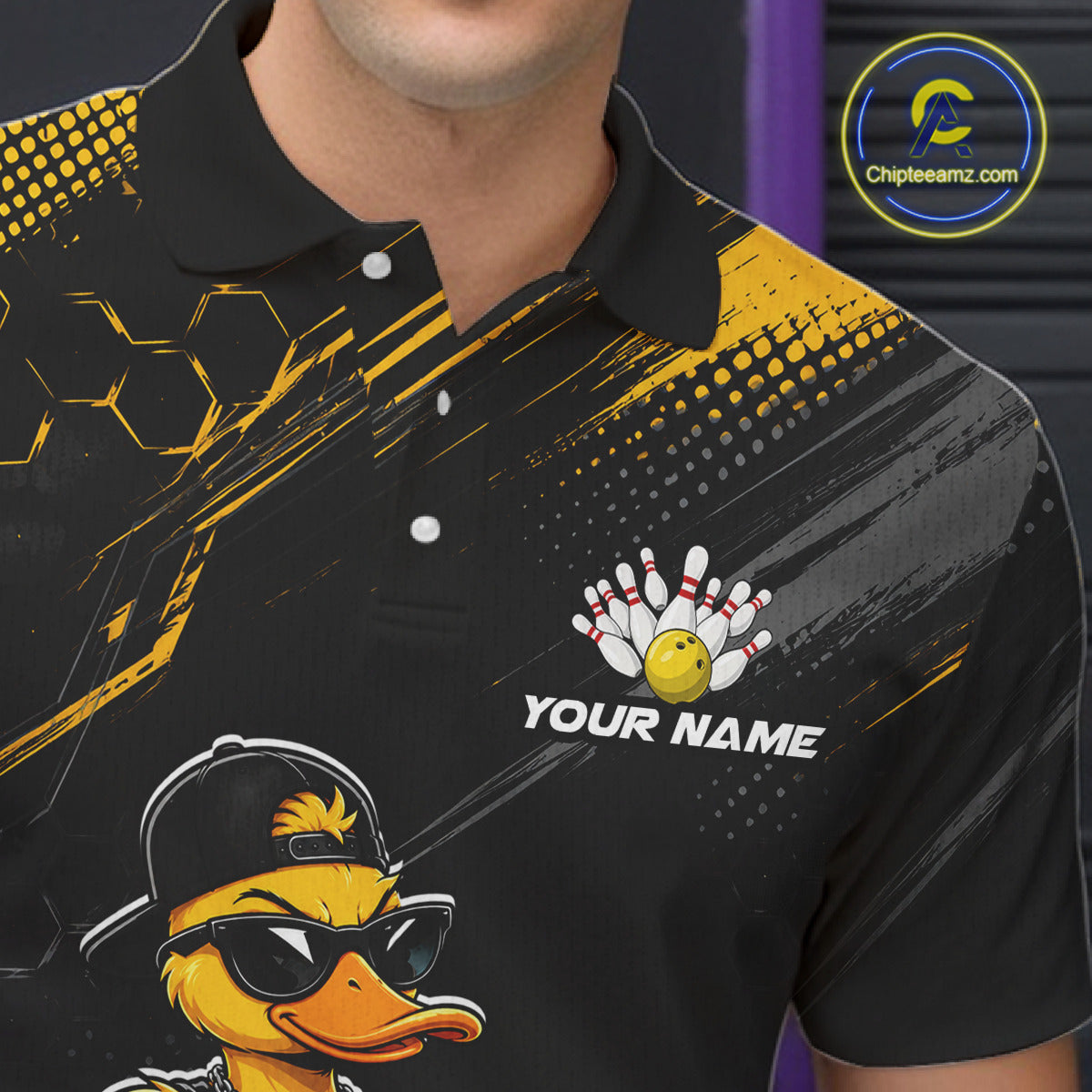 Black polo shirt with yellow accents and a duck graphic, featuring 'Your Name' text.