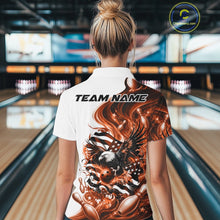 Load image into Gallery viewer, Female model back view in a bowling lane wearing a white and orange polo shirt with eagle artwork and flowing American flag inspired graphics.