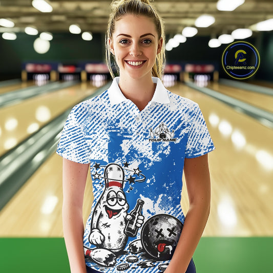 Female model at a bowling lane wearing a blue and white polo shirt, humorous drunk bowling pin artwork with beer bottle and bowling ball.