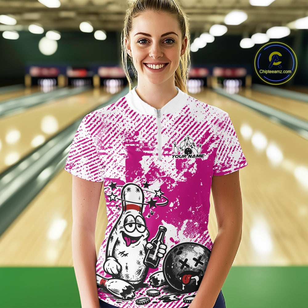 Front view female model in pink and white bowling quarter zip shirt inside bowling lane, playful bowling pin beer drinking graphic artwork