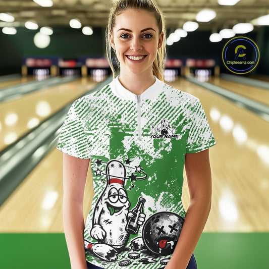 Front view female model wearing green and white bowling quarter zip shirt in bowling lane, playful cartoon bowling pin drinking beer graphic design