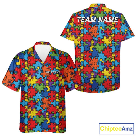 Front and back views of a short-sleeve button-up shirt featuring a colorful puzzle piece pattern in red, blue, yellow, green, and orange. The front has a V-neck and a small white placeholder text reading 'YOUR NAME', while the back has larger white placeholder text reading 'TEAM NAME'.