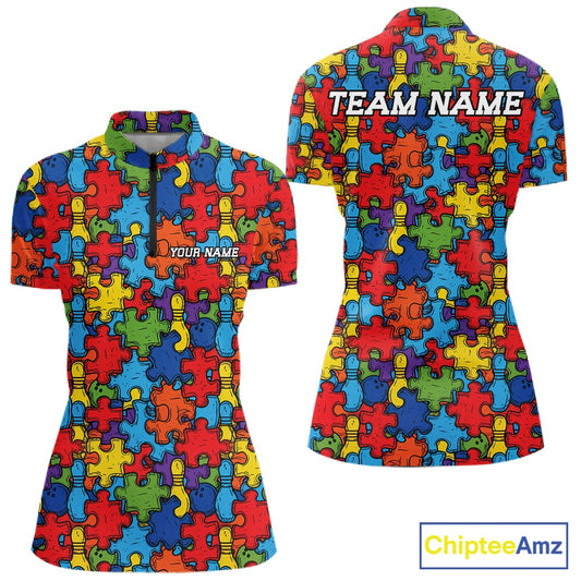 Front and back views of a short-sleeve polo shirt featuring a colorful autism awareness puzzle piece pattern. The front has a quarter-zip collar and the text 'YOUR NAME', while the back has 'TEAM NAME'.