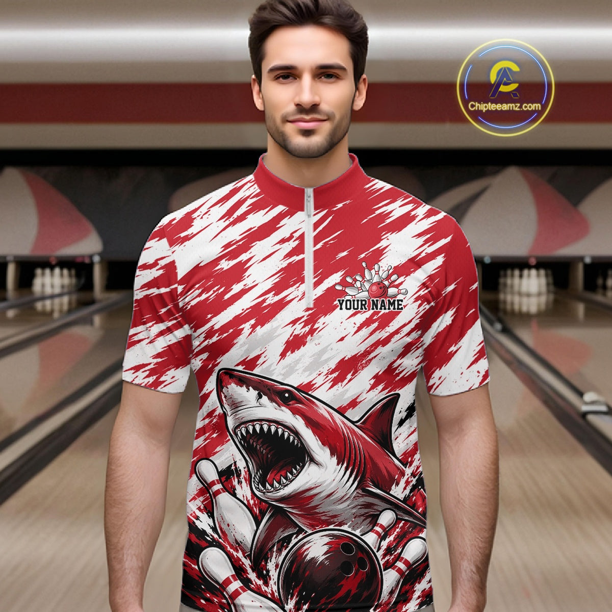 Man wearing a red and white shirt with a shark design in a bowling alley.