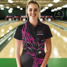 Load image into Gallery viewer, Female model front view in a bowling lane wearing a black polo shirt with a pink flaming black bowling ball striking pins in an energetic action scene.