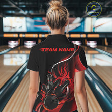 Load image into Gallery viewer, Female model back view at bowling lane wearing black and red polo shirt showcasing flame bowling ball striking pins in bold dynamic artwork.