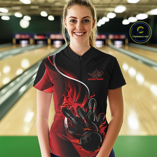 Female model front view at bowling lane wearing black and red quarter zip shirt with flame bowling strike themed graphics
