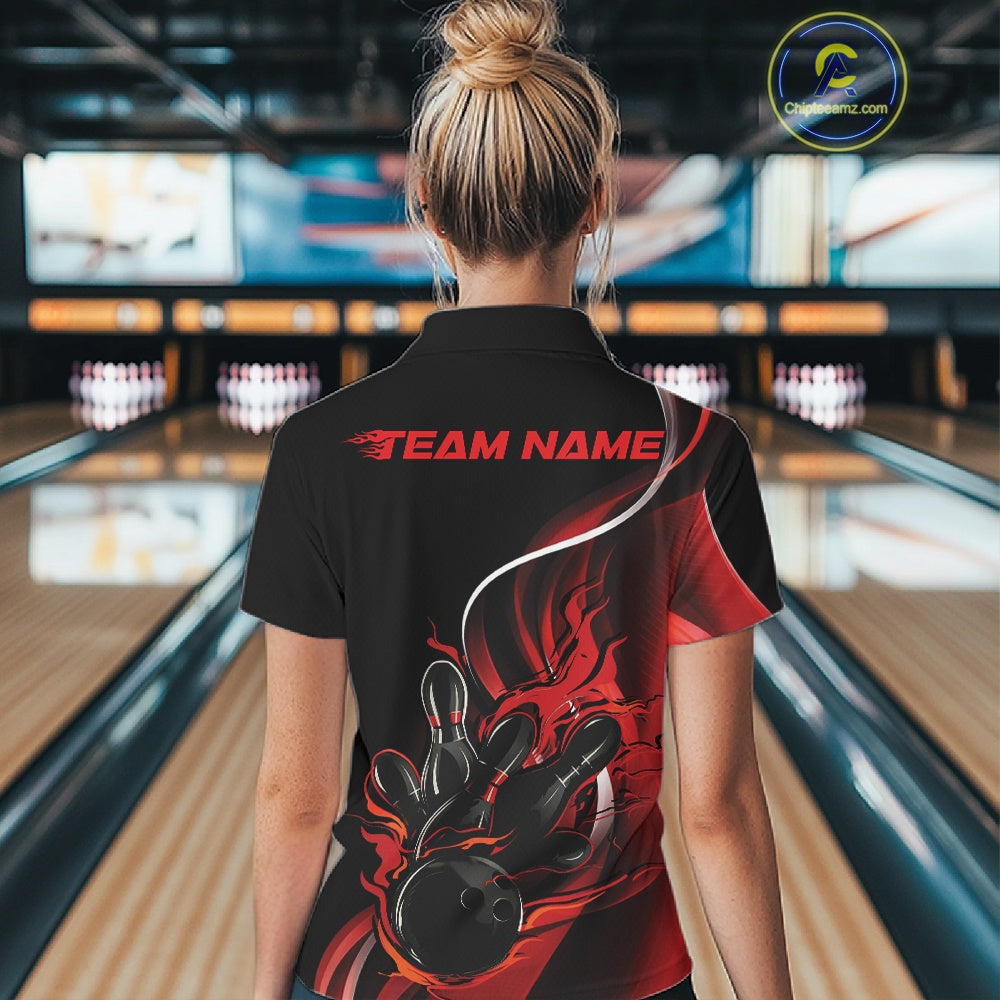 Back view female model inside bowling center wearing black and red quarter zip shirt featuring flaming bowling ball hitting pins design