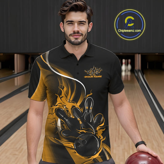 Male model seen from the front in a bowling lane wearing a black and yellow polo shirt featuring a flame bowling ball striking pins in a dynamic sports action scene.