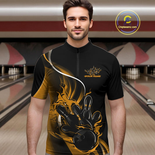 Male model front view at bowling lane wearing black and yellow quarter zip shirt with flame bowling strike graphics and energetic design