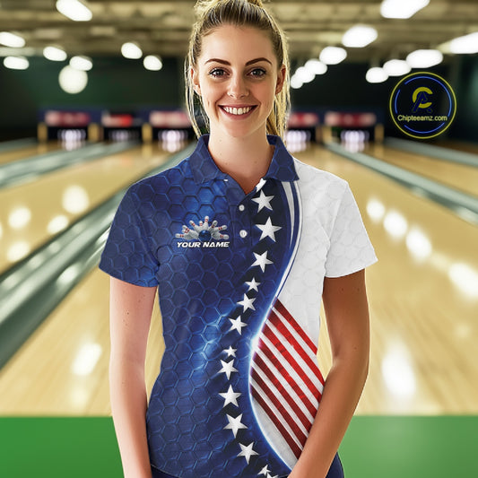 A woman standing in a bowling alley wearing a custom patriotic bowling shirt with a blue and white American flag design, featuring white stars and red and white stripes.