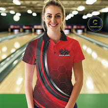 Load image into Gallery viewer, Female model in a bowling alley wearing a black and red polo shirt with honeycomb texture and a dynamic flame bowling strike graphic.