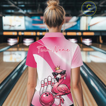 Load image into Gallery viewer, Back view of a female model in a bowling venue wearing a pink polo shirt featuring a crowned flamingo and bowling ball artwork.