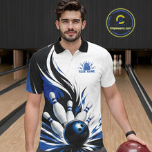 Load image into Gallery viewer, Front view of a male model wearing a white, black, and blue bowling polo shirt showcasing a flaming bowling ball striking pins graphic in a bowling lane.
