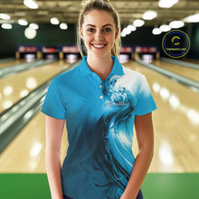 Load image into Gallery viewer, Female model wearing a blue bowling polo shirt with butterfly artwork and bowling graphics inside a bowling alley.